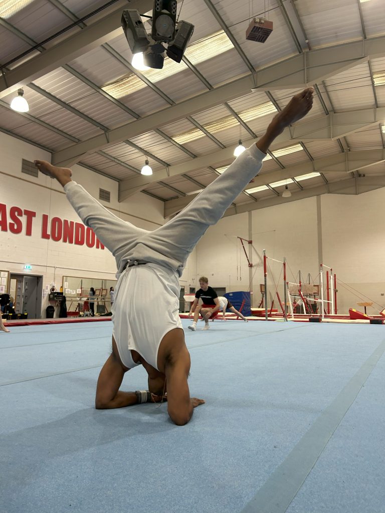 Fernando-Raymond-practicing-forearm-stand-at-the-East-London-Gymnastics-Club
